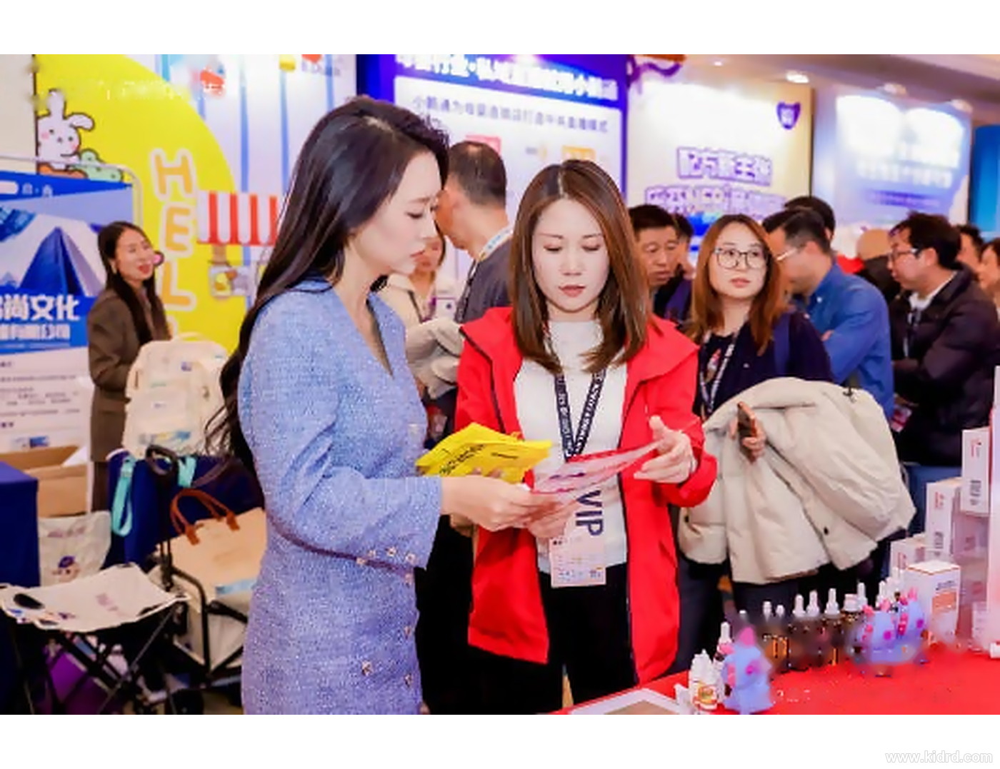 婴童行业展会现场,观众在母婴用品展位间交流